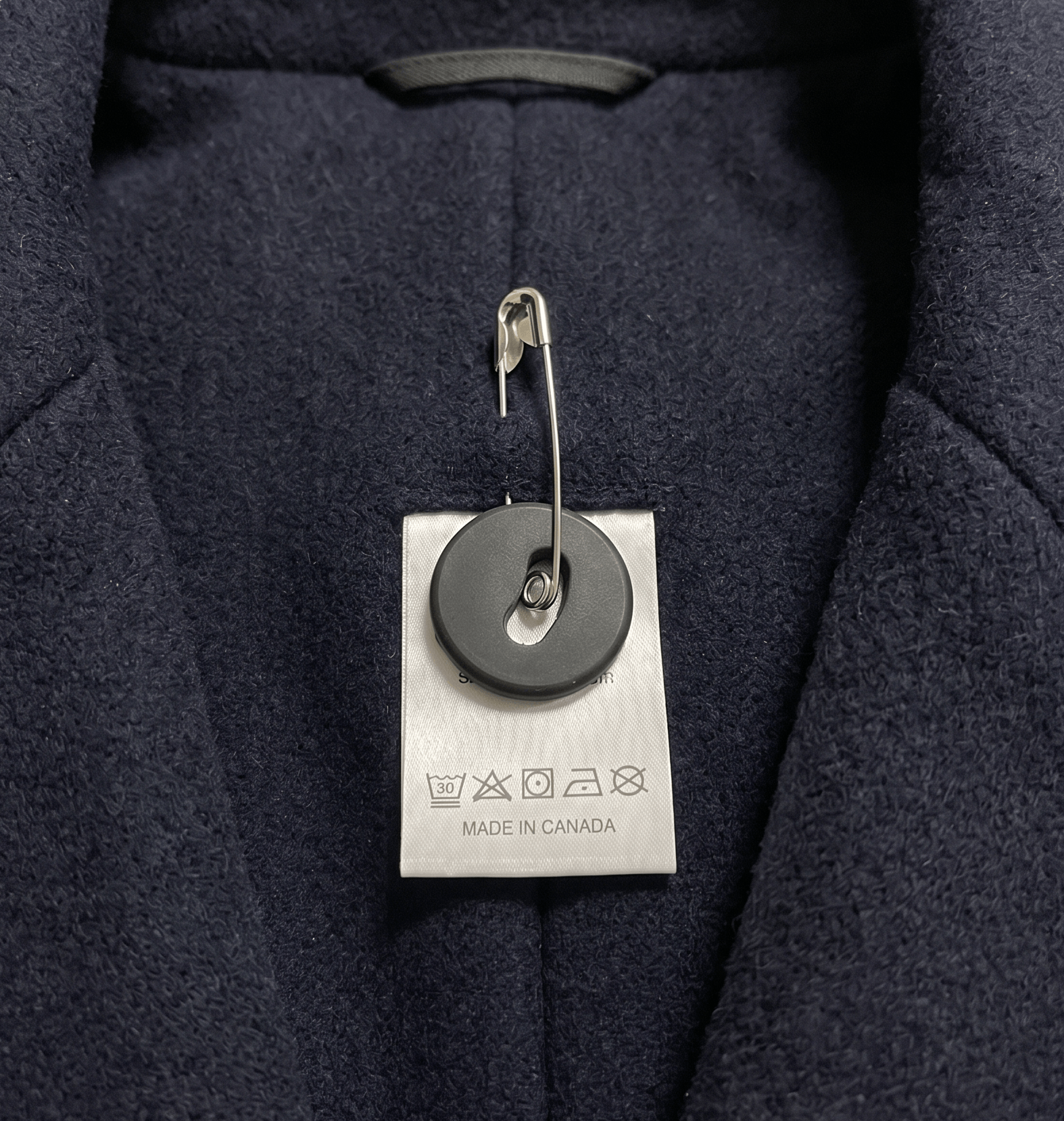 Sew-on button EveryTag on the inside of a jacket